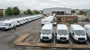 Fleet manager checking several company vans equipped with an effective mouse deterrent for car engine.